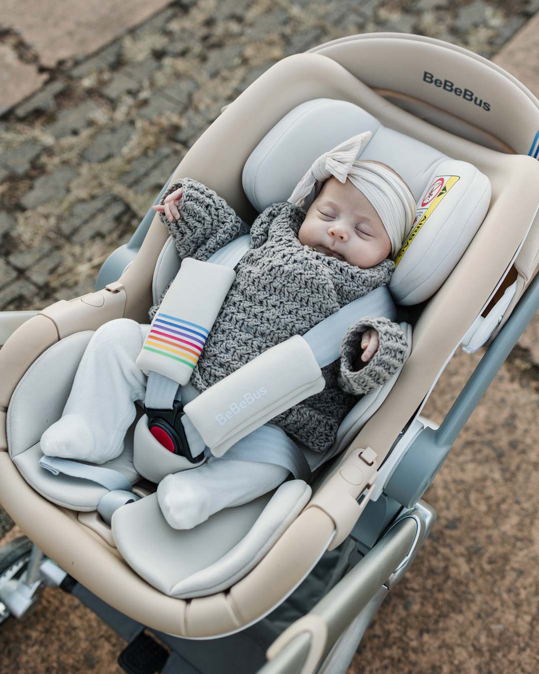 Baby peacefully sleeping in the BeBeBus Guard Car Seat, safely strapped in with a soft headrest and padded 5 point harness.