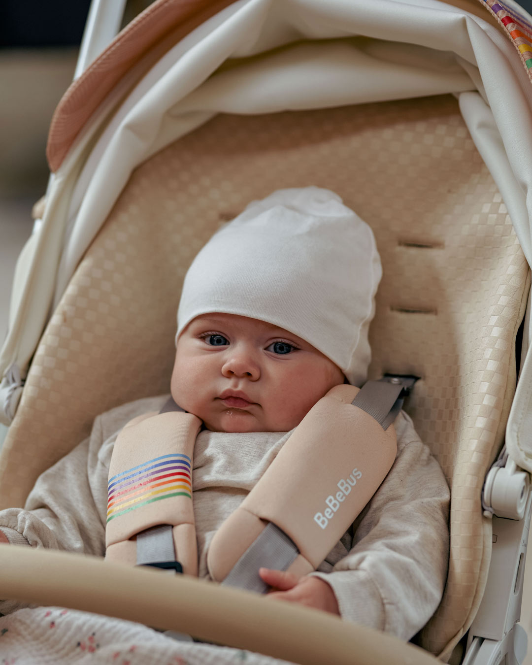 Baby snug in BeBeBus Art+ PRO Stroller during a walk, showcasing secure 5-point harness and padded comfort for infant safety on the go.