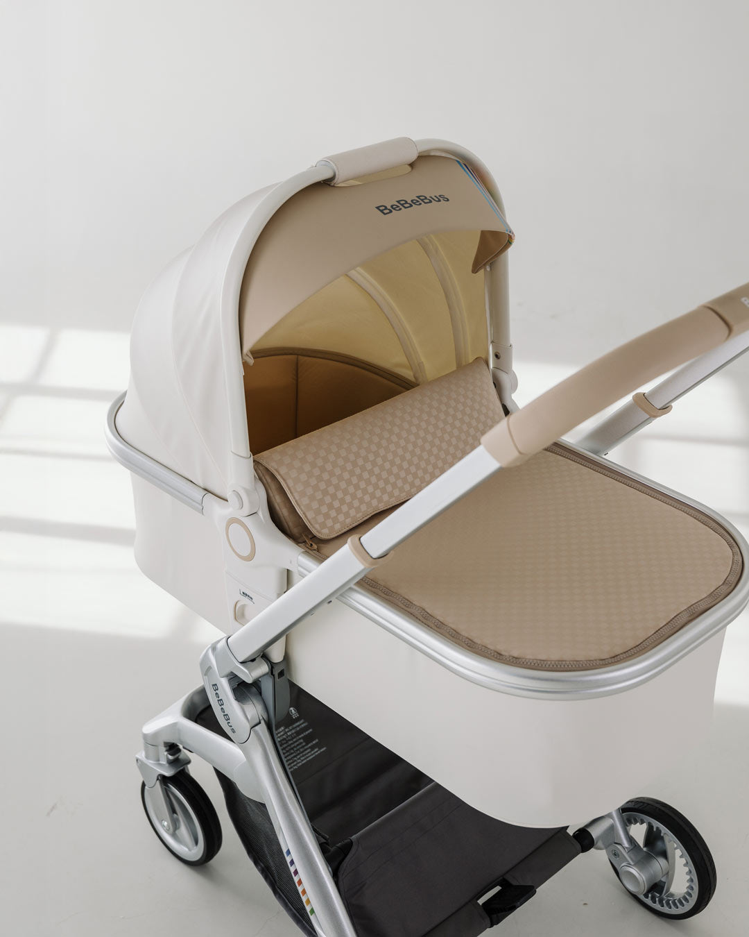 BeBeBus Bassinet clipped onto stroller frame, ideal for newborn travel systems.