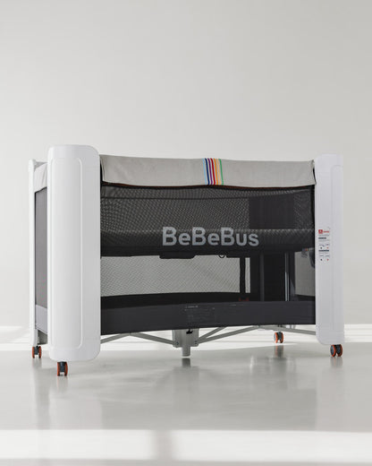 BeBeBus Wish Crib with breathable mesh sides and modern design, serving as a crib, co-sleeper, and playpen in one versatile solution.